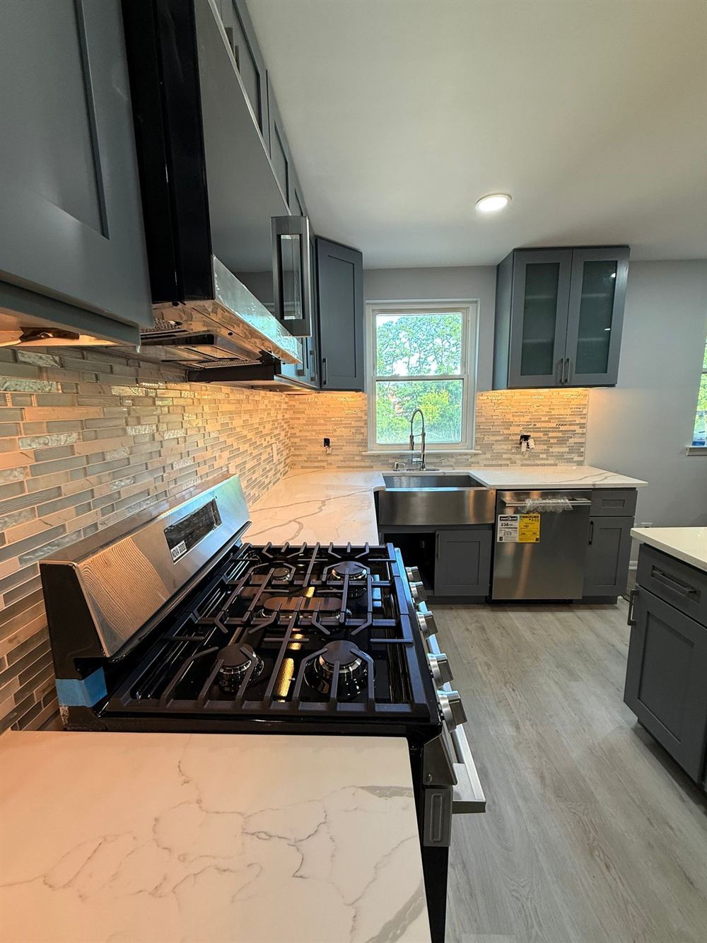 comparison of kitchen flooring materials including tile and vinyl plank